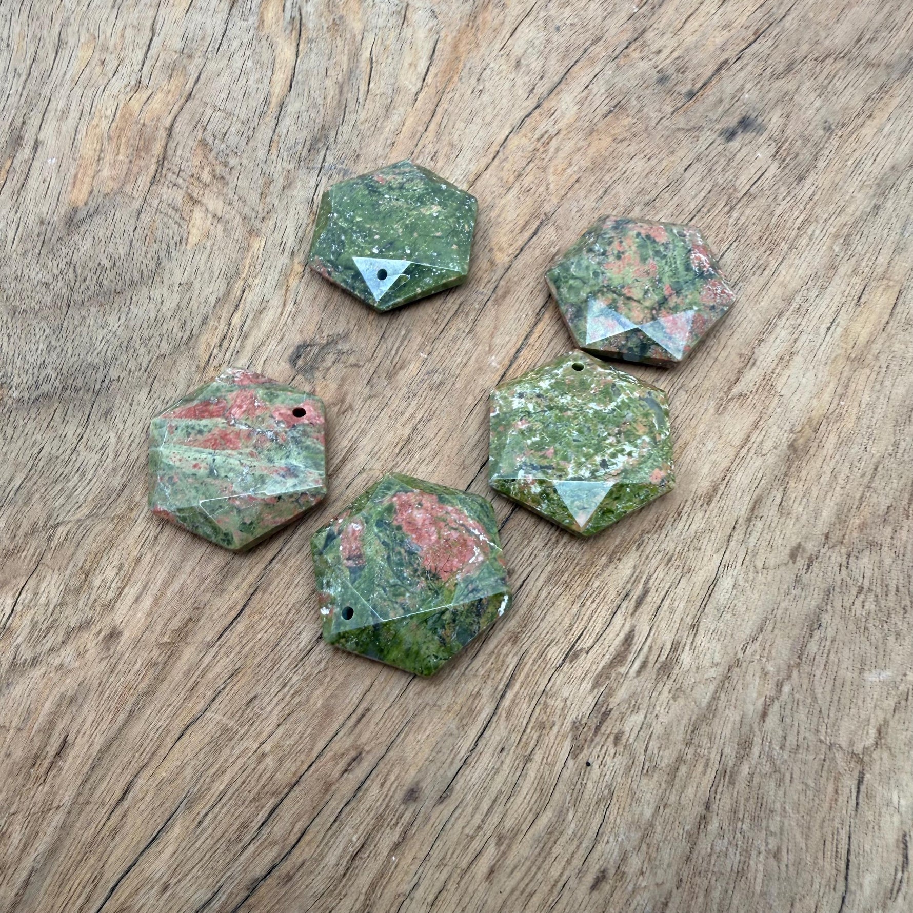 Faceted Unakite hexagon crystal pendant necklace with a natural stone bead, showcasing vibrant green and pink hues.