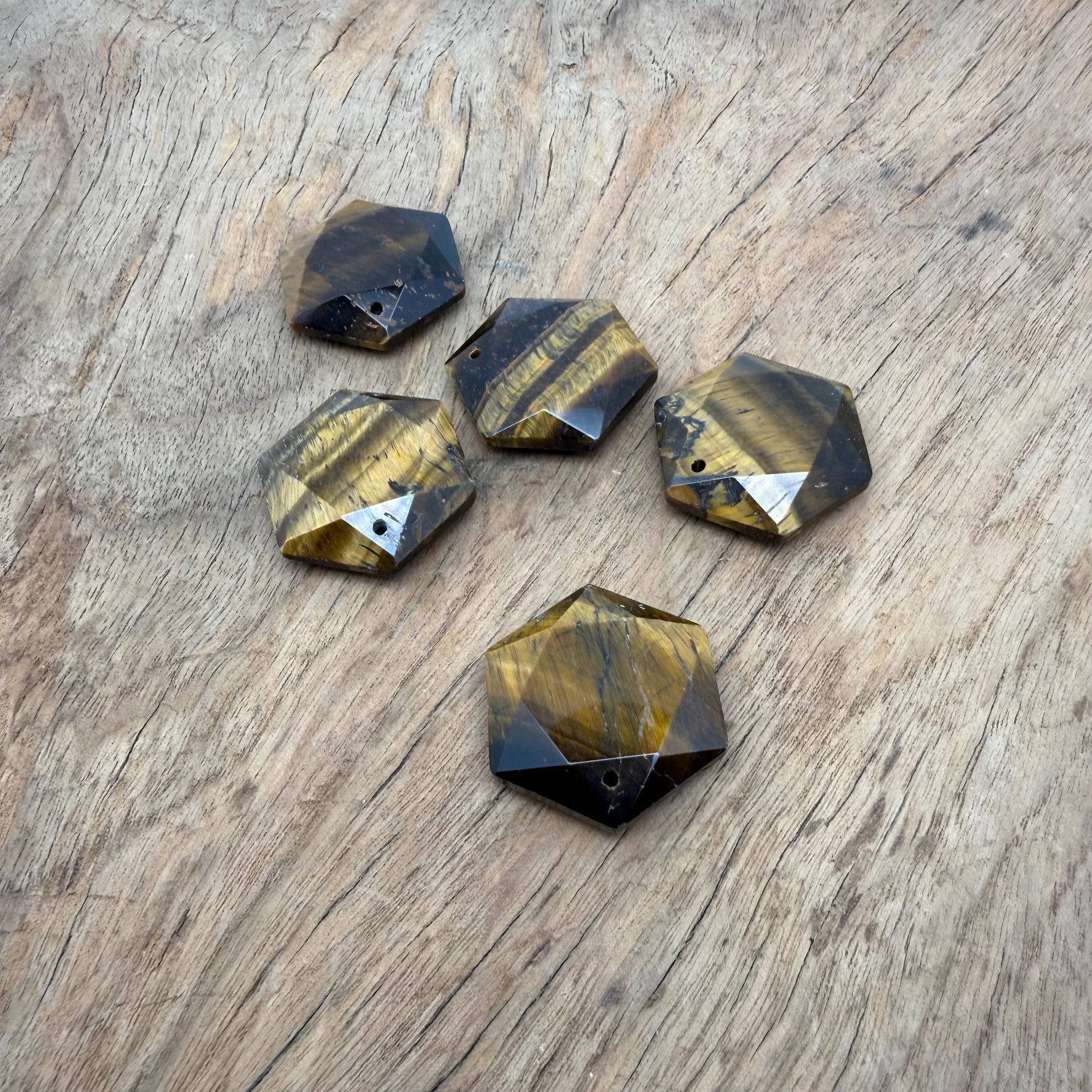 Faceted tiger eye hexagon crystal pendant necklace with gemstone bead, showcasing natural golden-brown stone and polished surface.