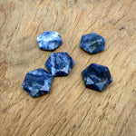 Faceted Sodalite hexagon crystal pendant necklace with gemstone bead, showcasing deep blue and white mineral patterns.