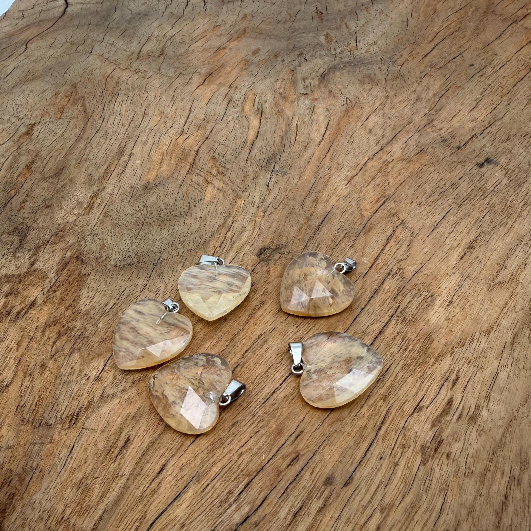 Faceted yellow smelting quartz heart crystal pendant with natural gemstone charm, showcasing a vibrant, polished gemstone from GemstoneGO.