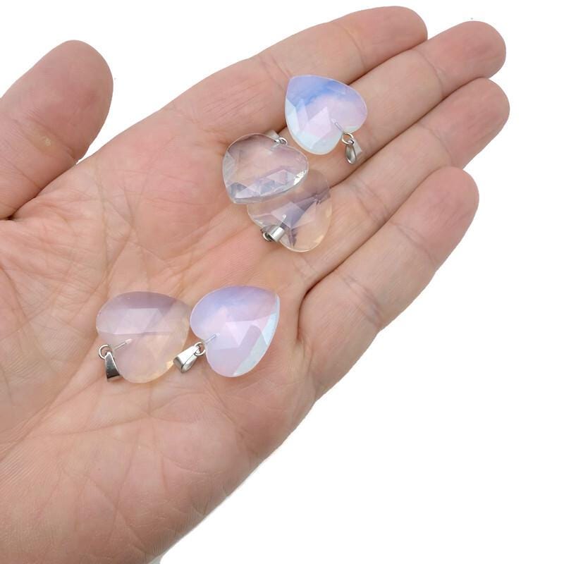 Opalite faceted heart crystal pendant by GemstoneGO showing a smooth, translucent heart-shaped gemstone with faceted surface.