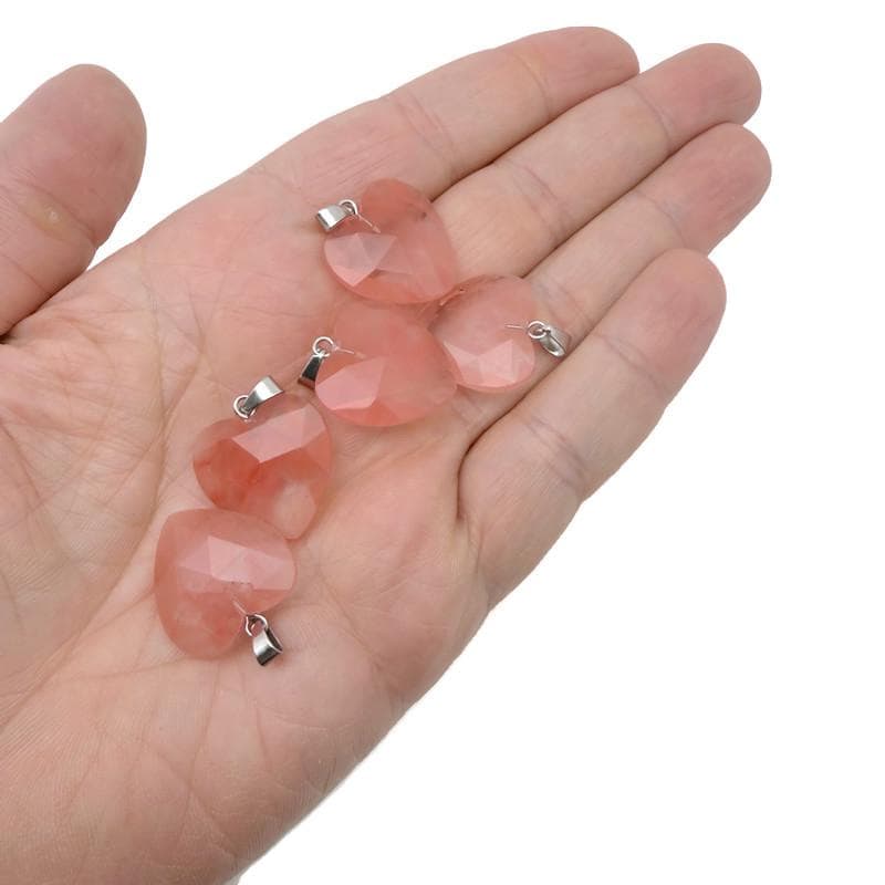 Faceted cherry quartz heart crystal pendant from GemstoneGO, natural gemstone charm with a polished, faceted surface.