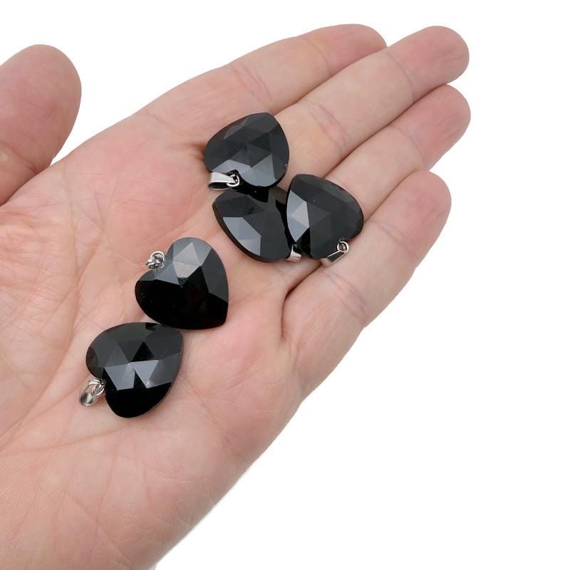 Faceted black obsidian heart-shaped crystal pendant from GemstoneGO, showcasing a natural crystal charm with a polished finish.