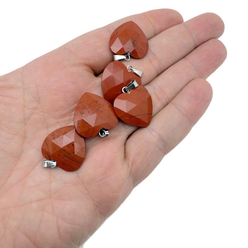 Red Jasper faceted heart crystal pendant from GemstoneGO, showcasing a natural red jasper stone with a polished heart shape.