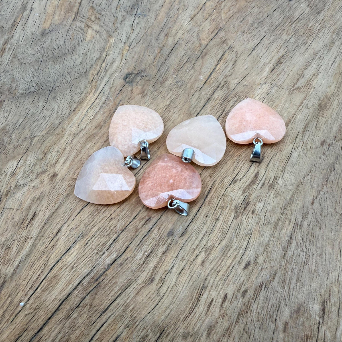 Faceted orange aventurine heart crystal pendant from GemstoneGO, showcasing a natural gemstone charm with detailed faceting.