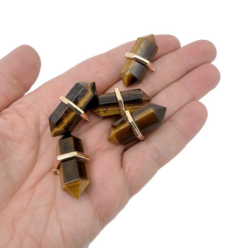 Natural tiger eye double terminated crystal pendant from GemstoneGO, showcasing a polished gemstone point with rich golden-brown hues.